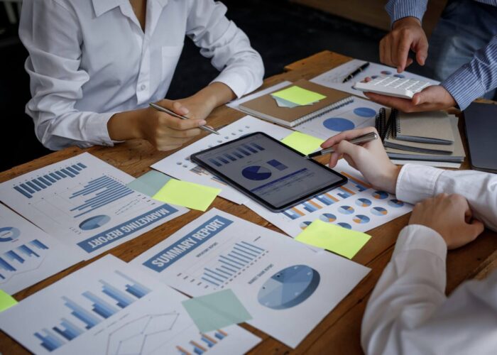 Financial analysts analyze business financial reports on a digital tablet planning investment projec